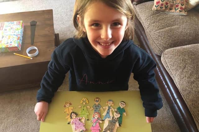 Annie Bond with the some of the keyworker bookmarks she has made with her mum Victoria to raise money for Alder Hey children's hospital.