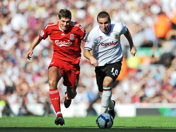 Martin Paterson is pursued by Steven Gerrard during a Premier League fixture between Liverpool and Burnley at Anfield.
