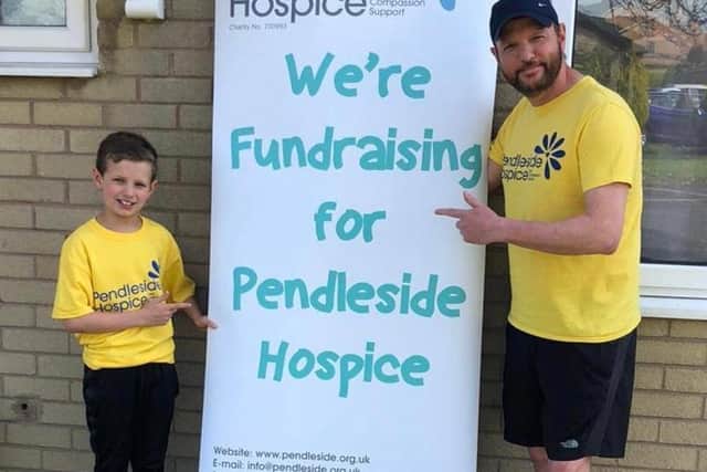 Andy Higginson, with his son Archie, plans to run the London Marathon at his home on Sunday.