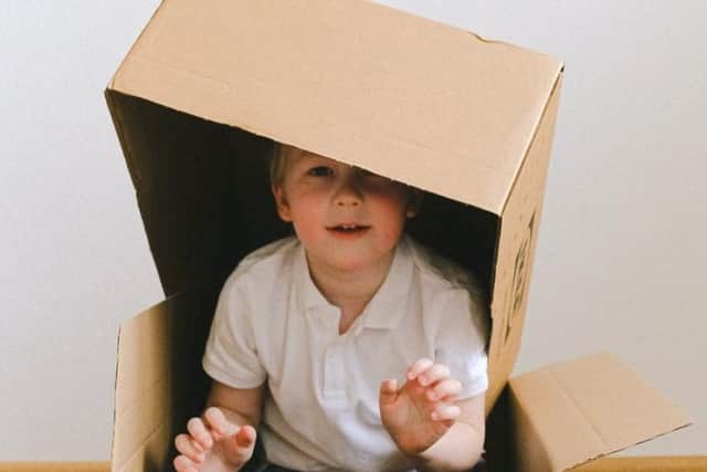A Burnley estate agent is raising money for the NHS by asking families to make houses from cardboard boxes and other recycled materials
