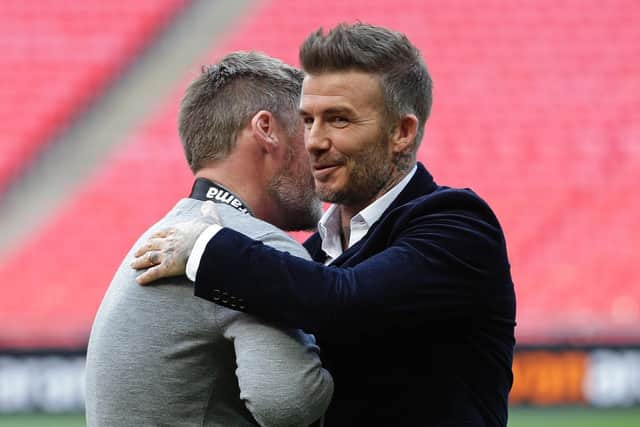 Salford City boss Graham Alexander and David Beckham embrace after the Vanarama National League Play Off Final between Salford City and AFC Fylde at Wembley Stadium.