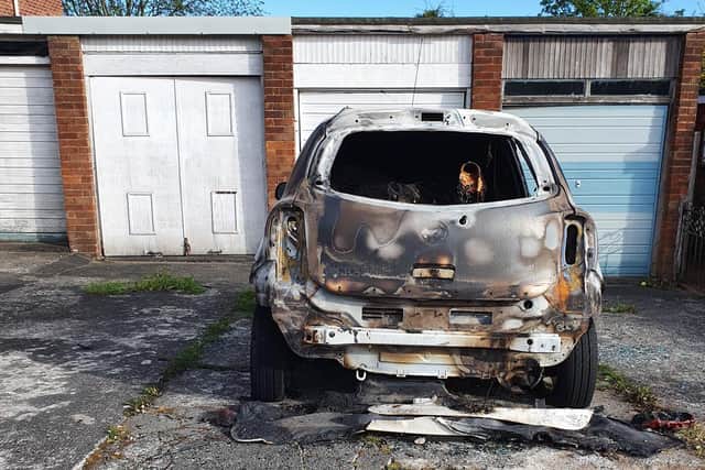 The burned out wreckage of Tracey's car after the arson attack