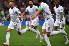 England's defender Kieran Trippier (L) is congratulated by teammates after scoring a goal during the Russia 2018 World Cup semi-final football match between Croatia and England at the Luzhniki Stadium in Moscow on July 11, 2018. (Photo by Alexander NEMENOV / AFP)
