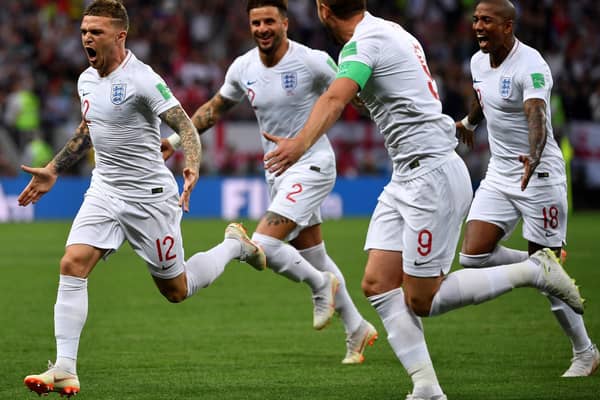 England's defender Kieran Trippier (L) is congratulated by teammates after scoring a goal during the Russia 2018 World Cup semi-final football match between Croatia and England at the Luzhniki Stadium in Moscow on July 11, 2018. (Photo by Alexander NEMENOV / AFP)