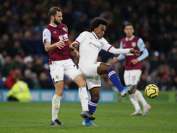 Erik Pieters challenges Chelsea's Willian, with Dwight McNeil looking on