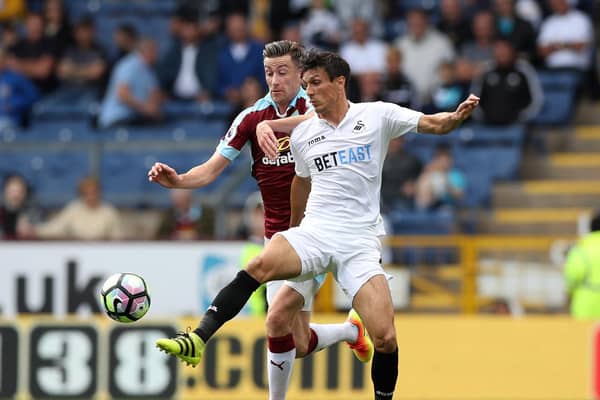 Former Clarets midfielder David Jones tussles with Jack Cork during the Barclays Premier League match between Burnley and Swansea City at Turf Moor on February 28, 2015. (Photo by Jan Kruger/Getty Images)