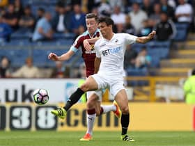 Former Clarets midfielder David Jones tussles with Jack Cork during the Barclays Premier League match between Burnley and Swansea City at Turf Moor on February 28, 2015. (Photo by Jan Kruger/Getty Images)