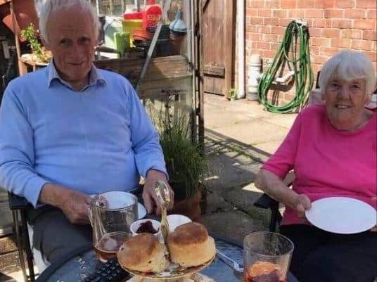 Geoff and Dot tuck into their afternoon tea treat for their Diamond wedding anniversary.