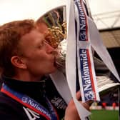 Preston North End manager David Moyes plants a kiss on the Division Two Championship trophy as the team clinched promotion