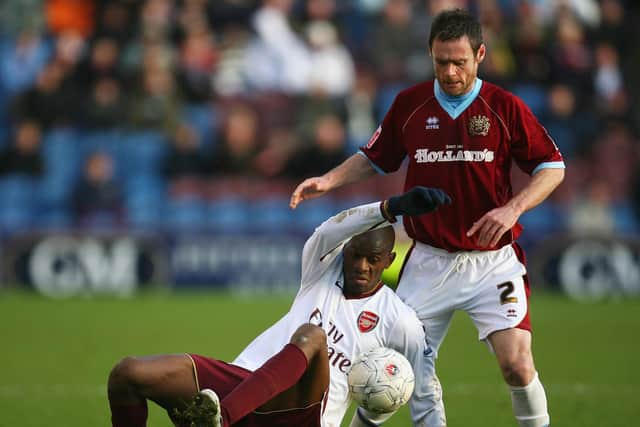 Abou Diaby of Arsenal is challenged by Graham Alexander of Burnley during the FA Cup Third Round match between Burnley and Arsenal at Turf Moor on January 6, 2008. (Photo by Alex Livesey/Getty Images)