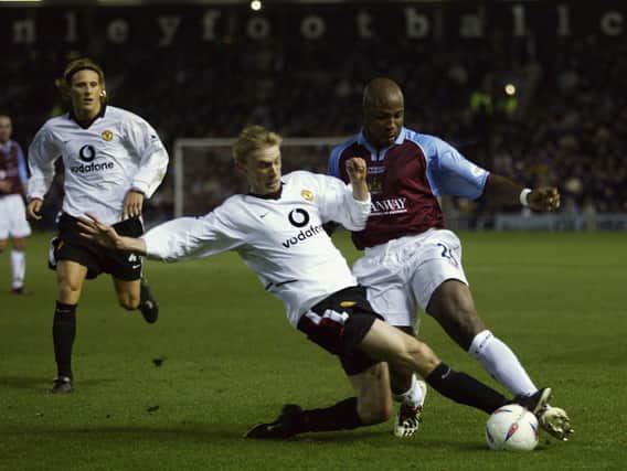 Luke Chadwick of Manchester United slide tackles Arthur Gnohere of Burnley during the Burnley v Manchester United Worthington Cup, Fourth Round match held on December 3, 2002 at Turf Moor in Burnley, England. Manchester United won the match 2-0. (Photo by Gary M. Prior/Getty Images)