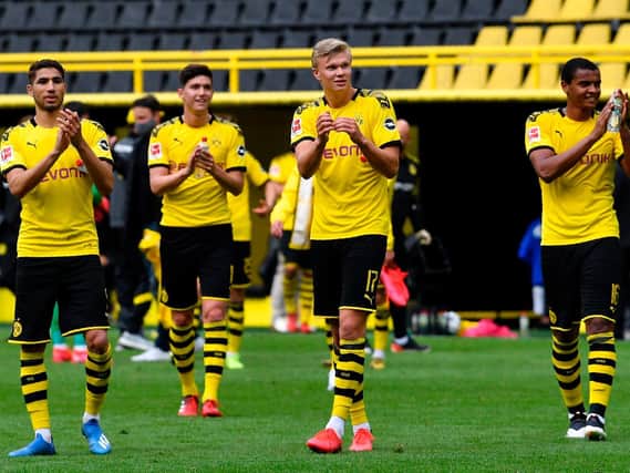 Dortmund's Norwegian forward Erling Braut Haaland (C) celebrates with his teammates after their 4-0 victory v Schalke 04 on May 16, 2020. (Photo by Martin Meissner / POOL / AFP)