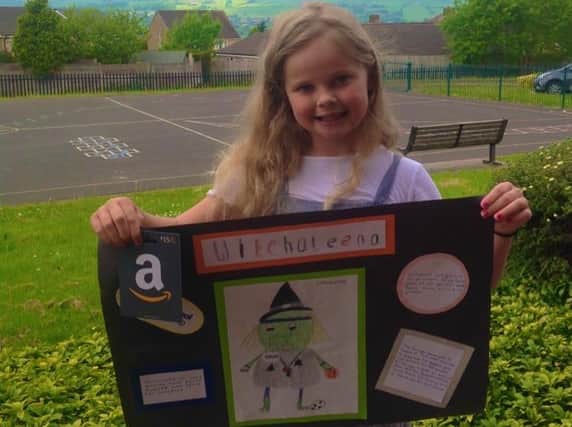 Chloe proudly shows off her winning mascot design which will be used to represent all schools in Pendle in the Lancashire Spar School Games