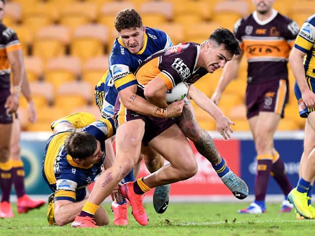 Herbie Farnworth of the Broncos attempts to break away from the defence during the round three NRL match between the Brisbane Broncos and the Parramatta Eels at Suncorp Stadium