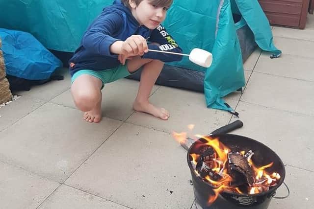 Toasting marshmallows was one of the treats at the virtual camp out at home