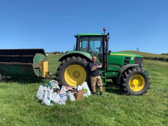 Angry farmer Mark Hanson with some of the rubbish he collected from his land at the weekend