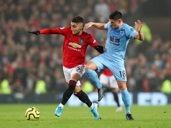 Andreas Pereira of Manchester United battles for possession with Ashley Westwood of Burnley during the Premier League match between Manchester United and Burnley FC at Old Trafford on January 22, 2020 in Manchester, United Kingdom. (Photo by Alex Livesey/Getty Images).