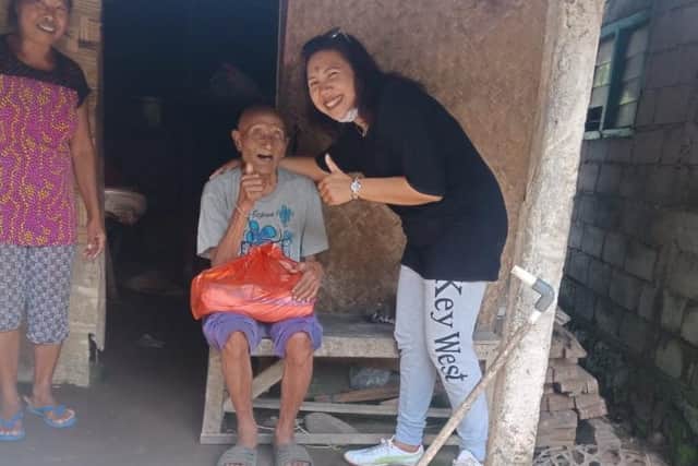 Eka delivers food that  sales of the masks have enabled her to buy for other families in neighbouring villages.