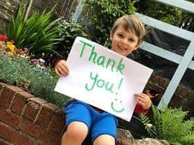 Toby Edwards, Joannes first rainbow boy, holding a thank you sign for everyone who nominated the charity