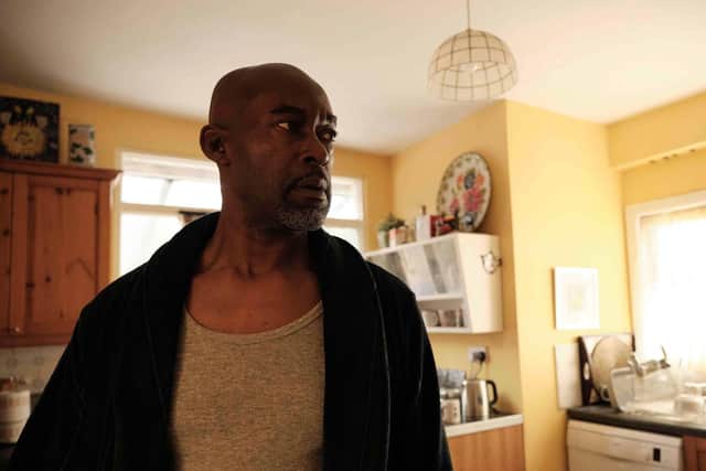 Anthony Bryan (Patrick Robinson) hears a knock at the door in the BBC's Windrush drama Sitting in Limbo