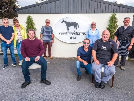 Burnley MP Antony Higginbotham (front left) with Kettledrum Inn owners, brothers Steve and Robin Reid (front right) and some of the volunteers. Photo: Lewis Welch