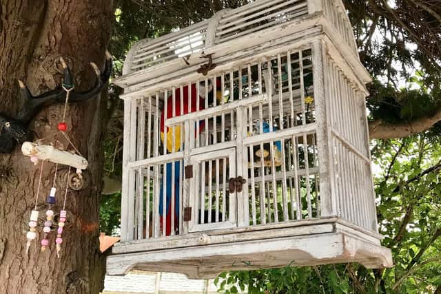 The ornamental birdcage in the garden of Des Connor and Cath Brown, Wateringpool Lane, Preston, complete with plastic parrot, which people mistook for a real bird in distress and called out the RSPCA