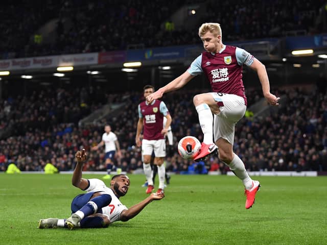 Japhet Tanganga of Tottenham Hotspur and Ben Mee of Burnley clash during the Premier League match between Burnley FC and Tottenham Hotspur at Turf Moor on March 07, 2020 in Burnley, United Kingdom. (Photo by Michael Regan/Getty Images)