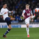 Burnley captain Ben Mee clears the danger as Spurs' Dele Alli applies the pressure at Turf Moor