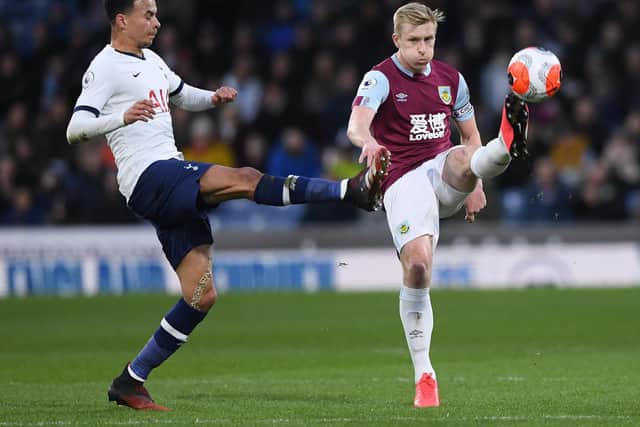 Burnley captain Ben Mee clears the danger as Spurs' Dele Alli applies the pressure at Turf Moor