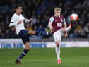 Burnley captain Ben Mee clears the danger as Spurs' Dele Alli applies the pressure at Turf Moor