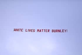 A plane flies over the stadium with a banner reading 'White Lives Matter Burnley' during the Premier League match between Manchester City and Burnley FC at Etihad Stadium on June 22, 2020 in Manchester, England. Football stadiums around Europe remain empty due to the Coronavirus Pandemic as Government social distancing laws prohibit fans inside venus resulting in all fixtures being played behind closed doors. (Photo by Shaun Botterill/Getty Images)