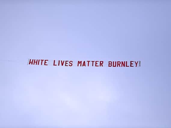 A plane flies over the stadium with a banner reading 'White Lives Matter Burnley' during the Premier League match between Manchester City and Burnley FC at Etihad Stadium on June 22, 2020 in Manchester, England. Football stadiums around Europe remain empty due to the Coronavirus Pandemic as Government social distancing laws prohibit fans inside venus resulting in all fixtures being played behind closed doors. (Photo by Shaun Botterill/Getty Images)