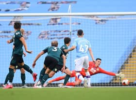 Phil Foden of Manchester City scores his teams first goal during the Premier League match between Manchester City and Burnley FC at Etihad Stadium on June 22, 2020 in Manchester, England. Football stadiums around Europe remain empty due to the Coronavirus Pandemic as Government social distancing laws prohibit fans inside venues resulting in all fixtures being played behind closed doors. (Photo by Michael Regan/Getty Images)