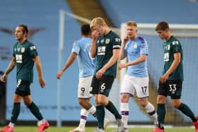 Ben Mee of Burnley reacts after the Premier League match between Manchester City and Burnley FC at Etihad Stadium on June 22, 2020 in Manchester, England. Football stadiums around Europe remain empty due to the Coronavirus Pandemic as Government social distancing laws prohibit fans inside venues resulting in all fixtures being played behind closed doors. (Photo by Martin Rickett/Pool via Getty Images)