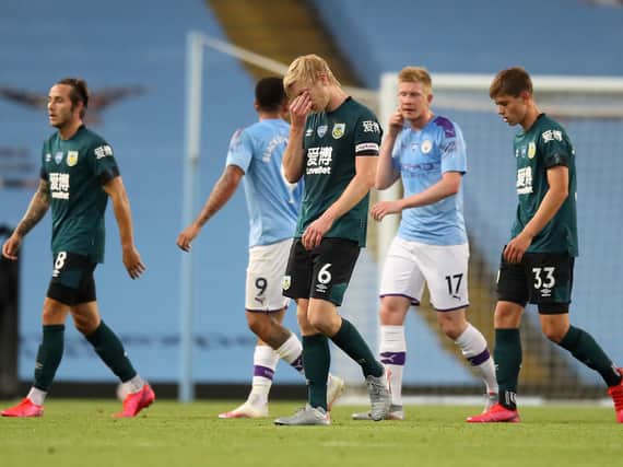 Ben Mee of Burnley reacts after the Premier League match between Manchester City and Burnley FC at Etihad Stadium on June 22, 2020 in Manchester, England. Football stadiums around Europe remain empty due to the Coronavirus Pandemic as Government social distancing laws prohibit fans inside venues resulting in all fixtures being played behind closed doors. (Photo by Martin Rickett/Pool via Getty Images)