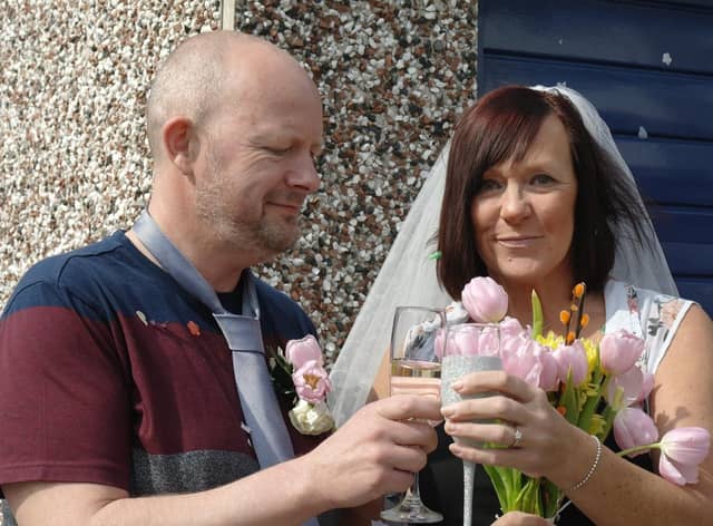 Susan and Dave toast each other on their surprise lockdown 'wedding' day organised by neighbours
