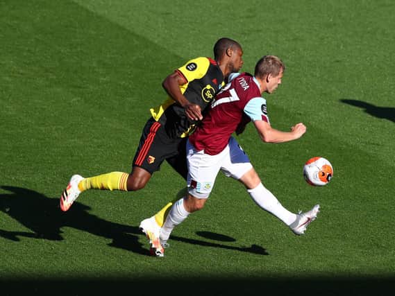 Matej Vydra of Burnley and Christian Kabasele of Watford battle for possession during the Premier League match between Burnley FC and Watford FC at Turf Moor on June 25