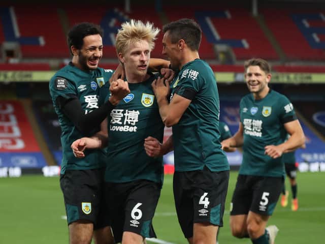 Ben Mee of Burnley celebrates with Jack Cork and Dwight McNeil after scoring his team's first goal during the Premier League match between Crystal Palace and Burnley FC at Selhurst Park on June 29, 2020 in London, United Kingdom. (Photo by Catherine Ivill/Getty Images)