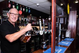Ighten Leigh Social Club steward Brian Parker is back behind the bar ready for Saturday's reopening. Photo: Kelvin Stuttard