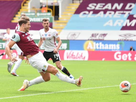 James Tarkowski of Burnley scores his team's first goal during the Premier League match between Burnley FC and Sheffield United at Turf Moor on July 05, 2020 in Burnley, England. (Photo by Peter Powell/Pool via Getty Images)