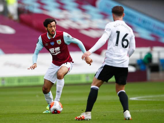 Dwight McNeil of Burnley takes on Ollie Norwood of Sheffield United during the Premier League match between Burnley FC and Sheffield United at Turf Moor on July 05, 2020 in Burnley, England. (Photo by Clive Brunskill/Getty Images)