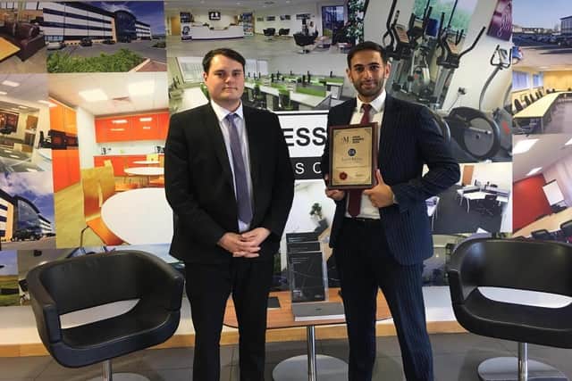 Proud Zafar shows his award to Business First centre manager Bradley Frayling where Eaton Adams is based.