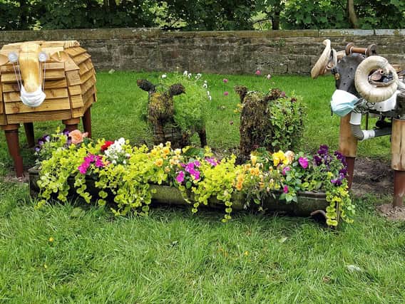 The recycled sheep, feeding from a flower-filled container