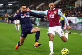 Dwight McNeil of Burnley is challenged by Ryan Fredericks of West Ham United during the Premier League match between Burnley FC and West Ham United at Turf Moor on November 09, 2019 in Burnley, United Kingdom. (Photo by Clive Brunskill/Getty Images)
