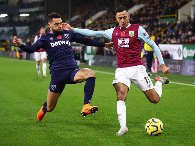 Dwight McNeil of Burnley is challenged by Ryan Fredericks of West Ham United during the Premier League match between Burnley FC and West Ham United at Turf Moor on November 09, 2019 in Burnley, United Kingdom. (Photo by Clive Brunskill/Getty Images)