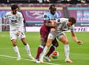 Michail Antonio of West Ham United battles for possession with James Tarkowski of Burnley during the Premier League match between West Ham United and Burnley FC at London Stadium on July 08, 2020 in London, England. (Photo by Justin Setterfield/Getty Images)