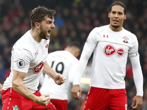 Jay Rodriguez (L) celebrates scoring his team's second goal with Dutch defender Virgil van Dijk during the English Premier League football match between Bournemouth and Southampton at the Vitality Stadium in Bournemouth, southern England on December 18, 2016. (ADRIAN DENNIS/AFP via Getty Images)
