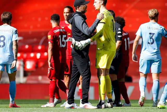 Jurgen Klopp in conversation with Nick Pope at full time at Anfield