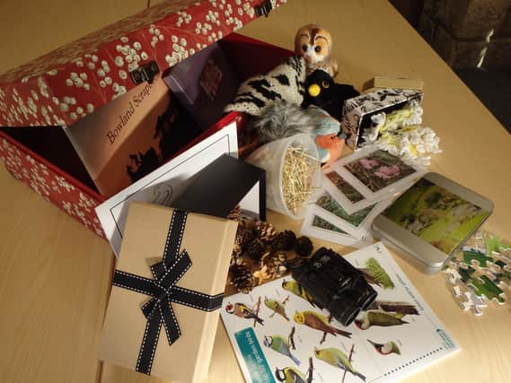 Creating a memory box. This box contains a range of resources which will evoke memories of visits to the Bowland AONB (Area of Outstanding Natural Beauty).