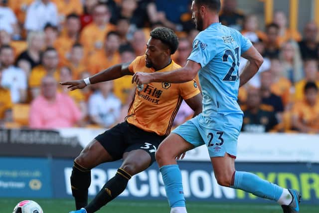 Adama Traore of Wolverhampton Wanderers takes on Erik Pieters during the Premier League match between Wolverhampton Wanderers and Burnley FC at Molineux on August 25, 2019 in Wolverhampton, United Kingdom. (Photo by David Rogers/Getty Images)